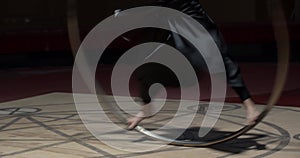 Gymnastics on a wheel, young muscular man is training before the circus show, 4k