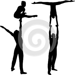 Gymnasts acrobats vector black silhouette on black background. Gymnasts acrobats vector photo