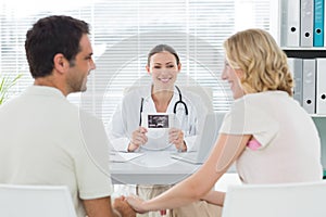 Gynaecologist looking at expectant couple