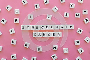 Gynecologic cancer word made of square letter word on pink background.