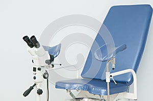 Gynecological chair and colposcope in clinic photo