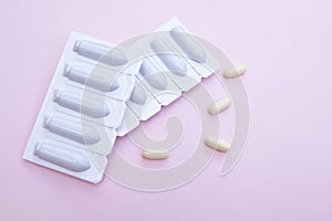 Gynecological medicines for women& x27;s health in form of suppository, capsules on pink background.