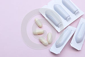 Gynecological medicines for women& x27;s health in form of suppository, capsules on pink background.