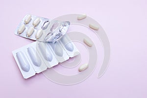 Gynecological medicines for women& x27;s health in form of suppository, capsules on pink background.