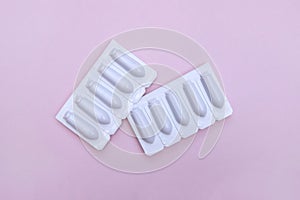 Gynecological medicines for women& x27;s health in form of suppository, capsules on pink background.