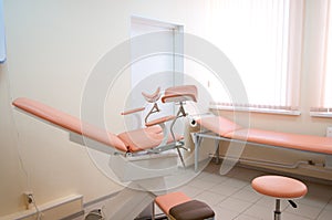 Gynecological room in hospital. Gynecological chair with a couch photo