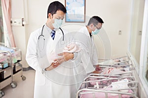 Gynecologist doctor holding a newborn baby photo