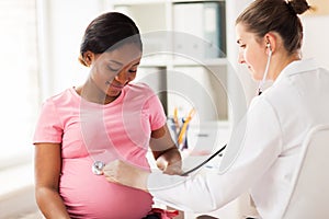 Gynecologist doctor and pregnant woman at hospital photo