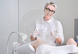 Gynecologist doctor in white uniform in hospital with medicine instrument vaginal speculum