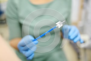 Gynecologist examines a patient takes a smear from a woman cervix. Close up view of doctor hands with gynecological cytobrush. photo