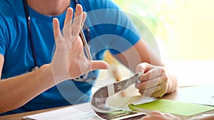 Gynecologist examines ultrasound of uterus of patient in medical office holds ahand with pen