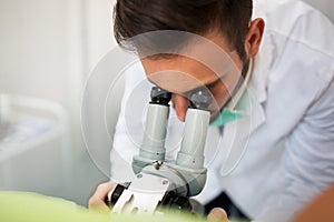 Gynecologist examining a patient with a colposcope