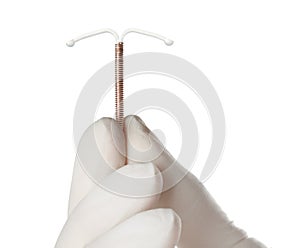 Gynecologist holding copper intrauterine contraceptive device on white background, closeup