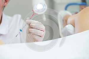 Gynecologist holding an IUD birth control device before using it for patient