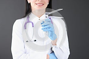 Gynecologist holding mirror instrument in his hands closeup