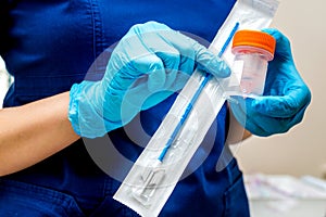 Gynecologist holds a brush for sampling liquid cytology