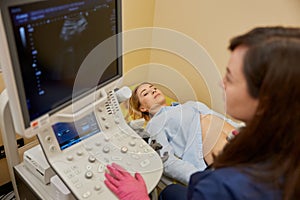 Gynecologist making ultrasonic diagnostic test for patient