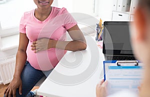 Gynecologist and pregnant woman at hospital