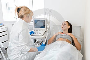 The gynecologist sets up the ultrasound machine and explains to the patient how the study will be performed. Ultrasound of the