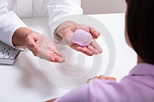 Gynecologist Showing Contraception Ring And Diaphragm
