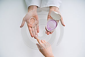 Gynecologist Showing Contraception Ring And Diaphragm