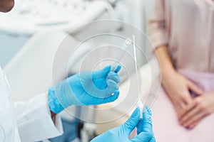 Gynecologist testing vaginal swab for STD