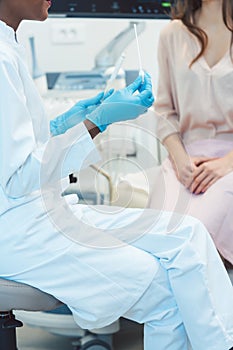 Gynecologist testing vaginal swab for STD