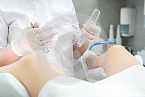 Gynecologist with vaginal speculum in clinic before patient examination