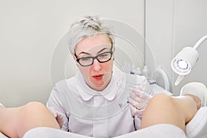 Gynecologist with vaginal speculum in clinic before patient examination