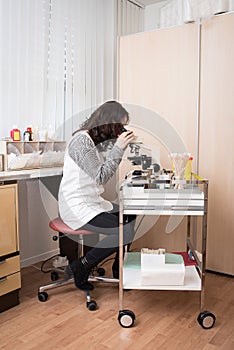 Gynecologist working with microscope