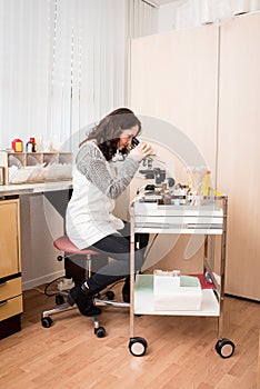 Gynecologist working with microscope
