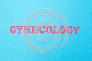 Gynecology inscription in red letters on a blue background. The concept of female diseases of the reproductive organs. surgical