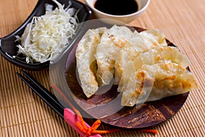 Gyoza dumplings on mini wooden dish, popular japanese food