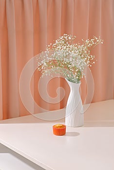 Gypsophila Baby`s breath flowers, in bottle on textured background. Beautiful light, airy masses of small white flowers. floral