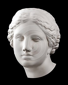 Gypsum copy of ancient statue Venus head isolated on black background. Plaster sculpture woman face.