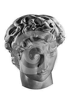 Gypsum copy of head statue David for artists. Copy of face famous sculpture youth of David focused on upcoming fight
