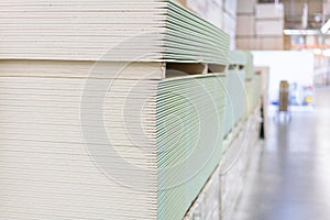 Gypsum plasterboard in the pack. The stack of gypsum board preparing for construction. Pallet with plasterboard in the