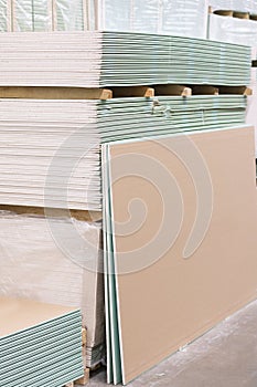 Gypsum plasterboard in the pack. The stack of gypsum board preparing for construction. Pallet with plasterboard in the building