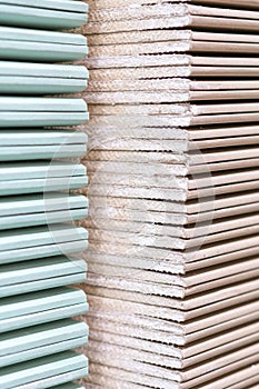 Gypsum plasterboard in the pack. The stack of gypsum board preparing for construction. Pallet with plasterboard in the building