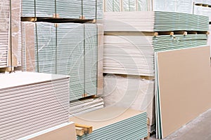 Gypsum plasterboard in the pack. The stack of gypsum board preparing for construction. Pallet with plasterboard in the building