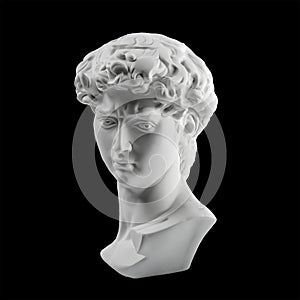 Gypsum statue of David`s head. Michelangelo`s David statue plaster copy isolated on black background. Ancient greek sculpture,