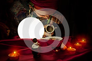 Gypsy clairvoyant woman reads a fortune from empty coffee cup