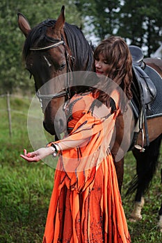 Gypsy girl with a bay horse