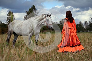 Gypsy girl with a grey horse