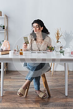 Gypsy soothsayer holding blurred tarot cards