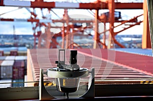 Gyro compass repeater on the cargo ship navigational bridge.