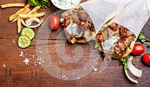 Gyro pita, shawarma, take away, street food. Traditional greek turkish, meat food on wooden table