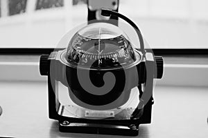 Gyrocompass on the dashboard of the boat close-up - an element of the watercraft control system