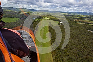 Gyrocopter is landing on an airfield out of gras, Byron Bay, Queensland, Australia photo