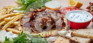 Gyros pita, Shawarma. Traditional greek, turkish meat food on pita bread and tzatziki, banner